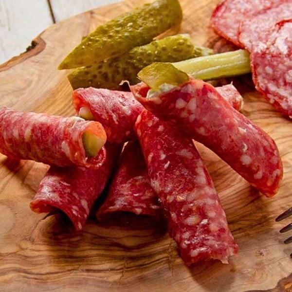Salami Roll Ups served up on a wooden board.