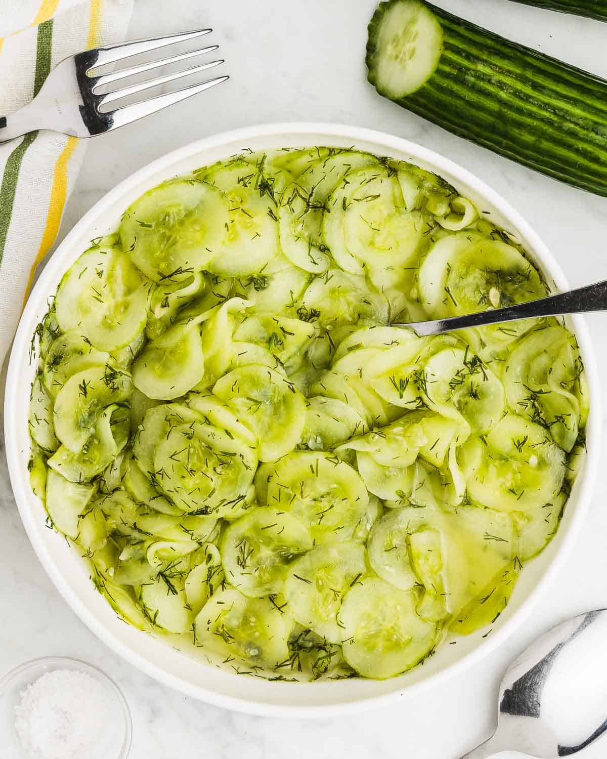 Fresh authentic German Cucumber Salad in a white bowl.