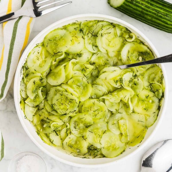German Cucumber Salad served in a white bowl.