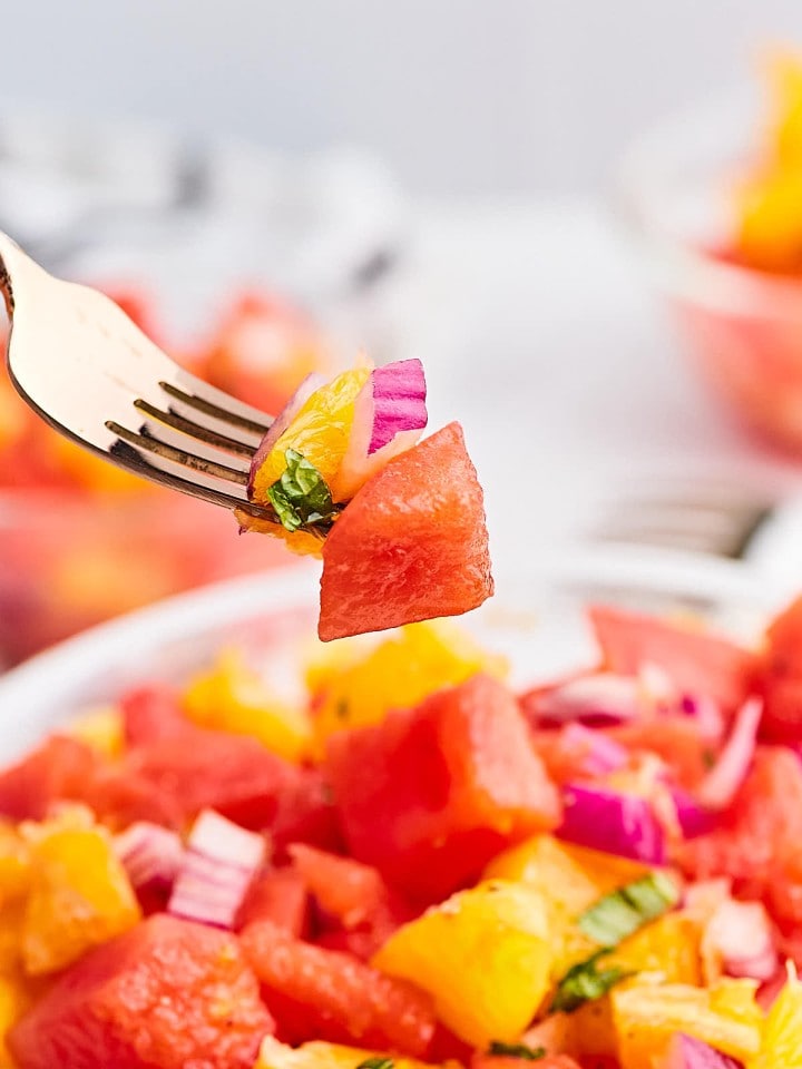 A forkful of Watermelon and Orange Salad.