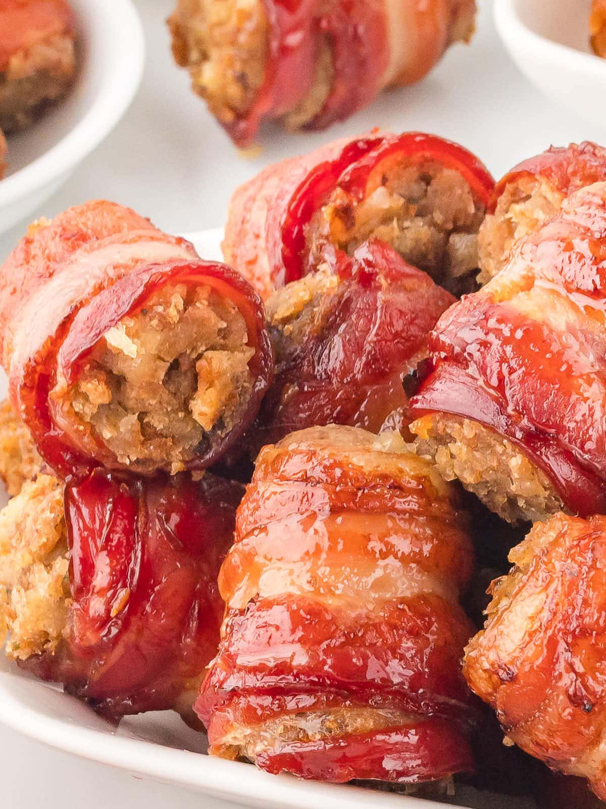 A pile of Bacon Stuffing Rolls on a white plate.