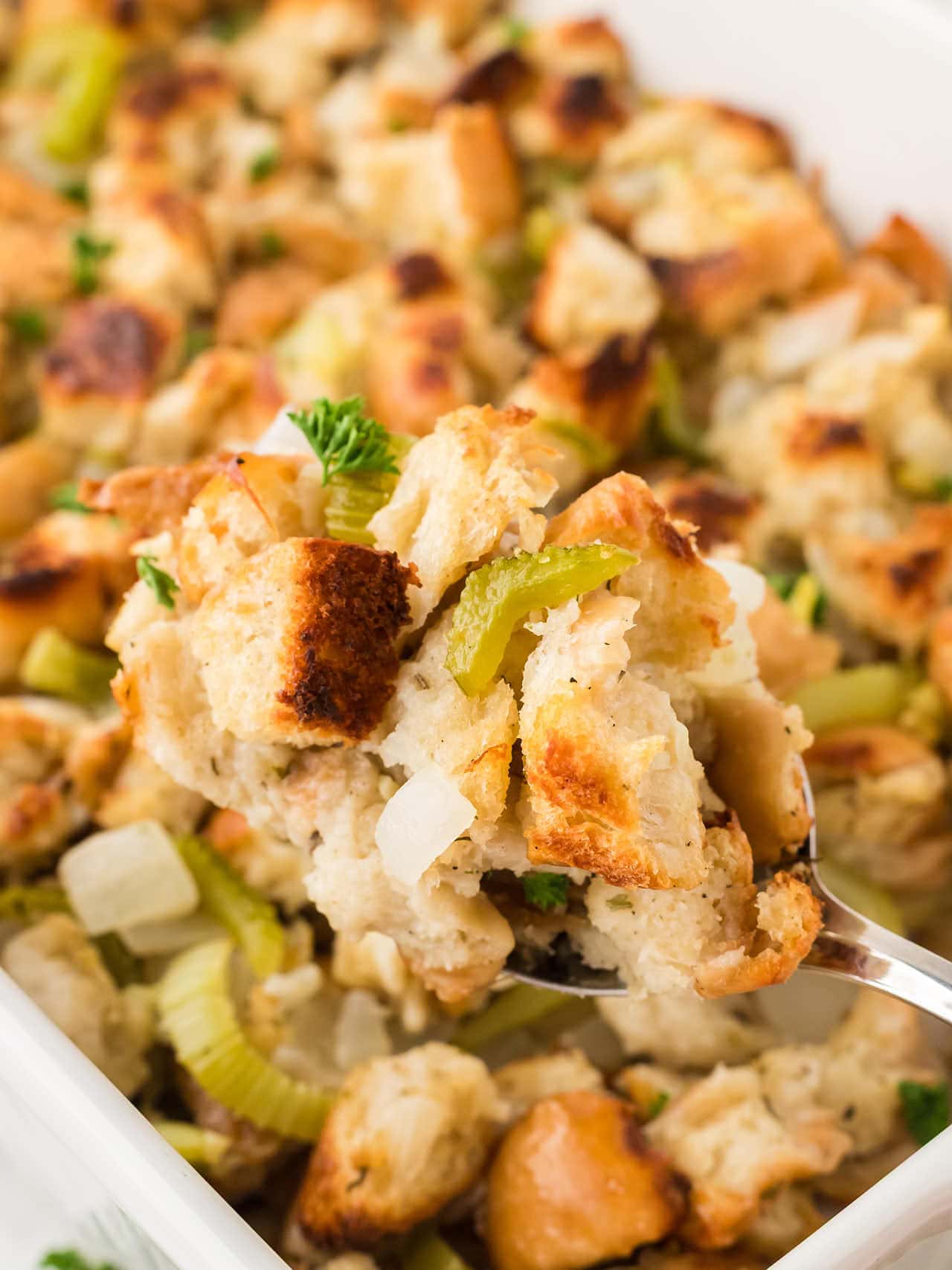 Spoonful of Homemade Stuffing with toasted bread cubes, celery, onions, and fresh parsley.