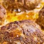 Closeup of cooked Frikadellen in a frying pan.
