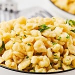 Cooked German Spätzle (egg noodles) in a white bowl.