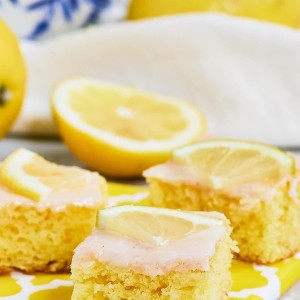 Slices of German Lemon Sponge Cake on a yellow serving platter.
