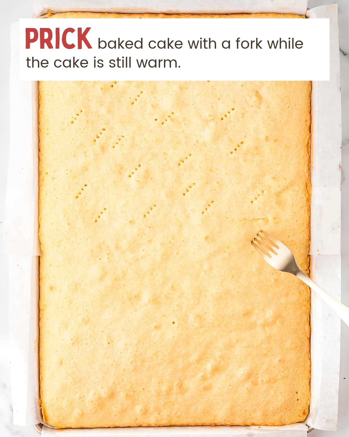 a baked cake with fork pricks and a fork making a prick.