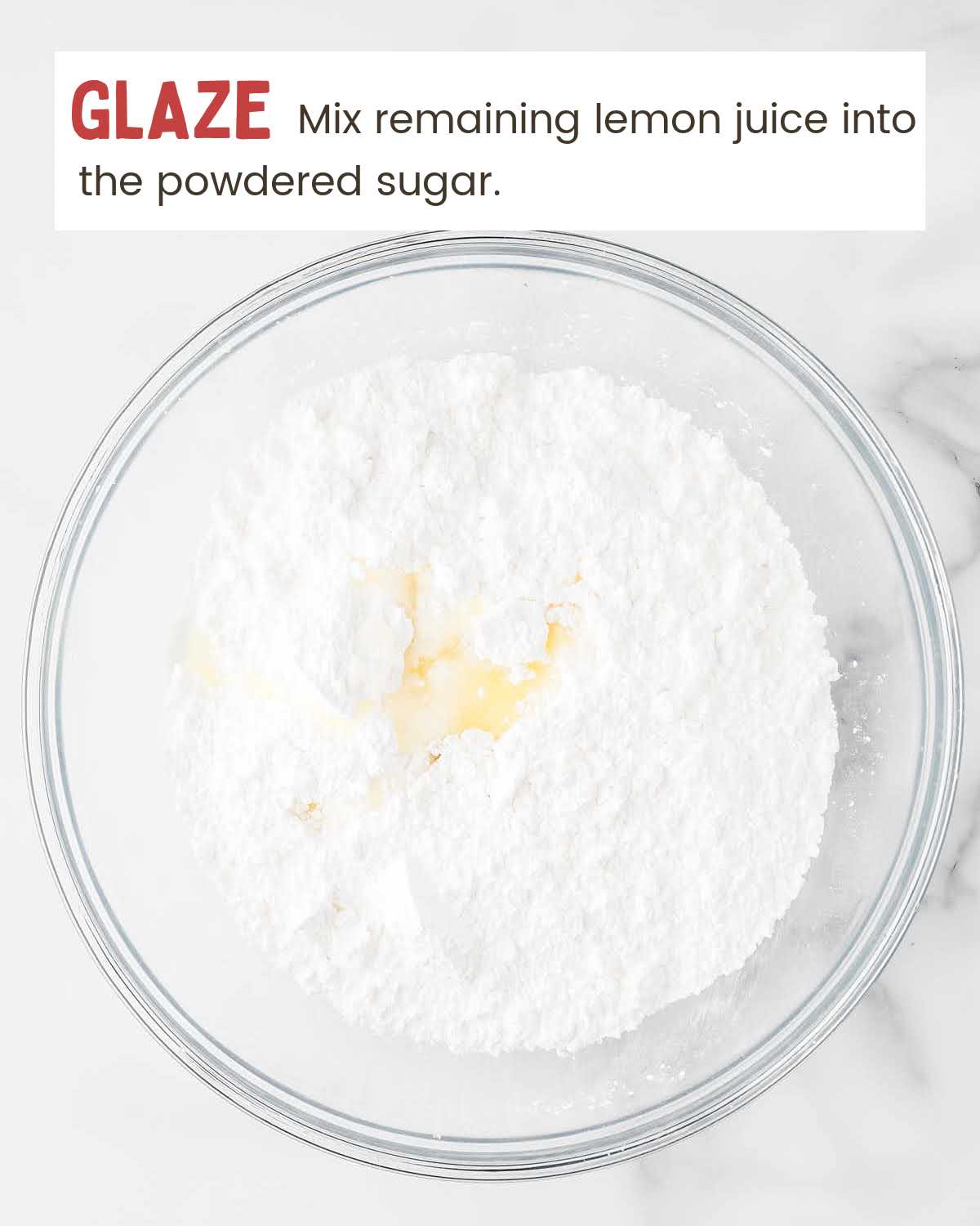 Lemon juice on top of powdered sugar in a bowl.