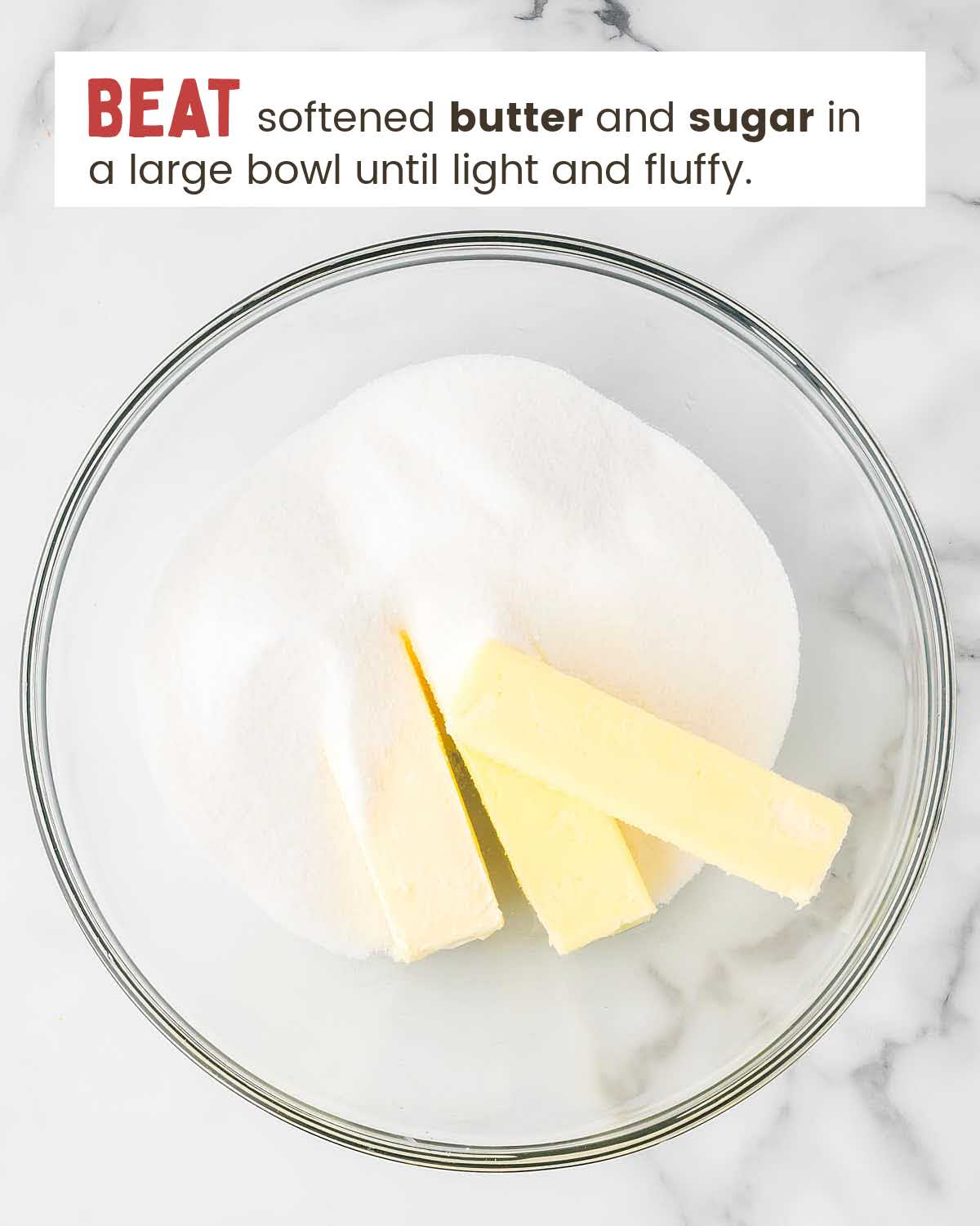 Three butter sticks and sugar in a bowl.