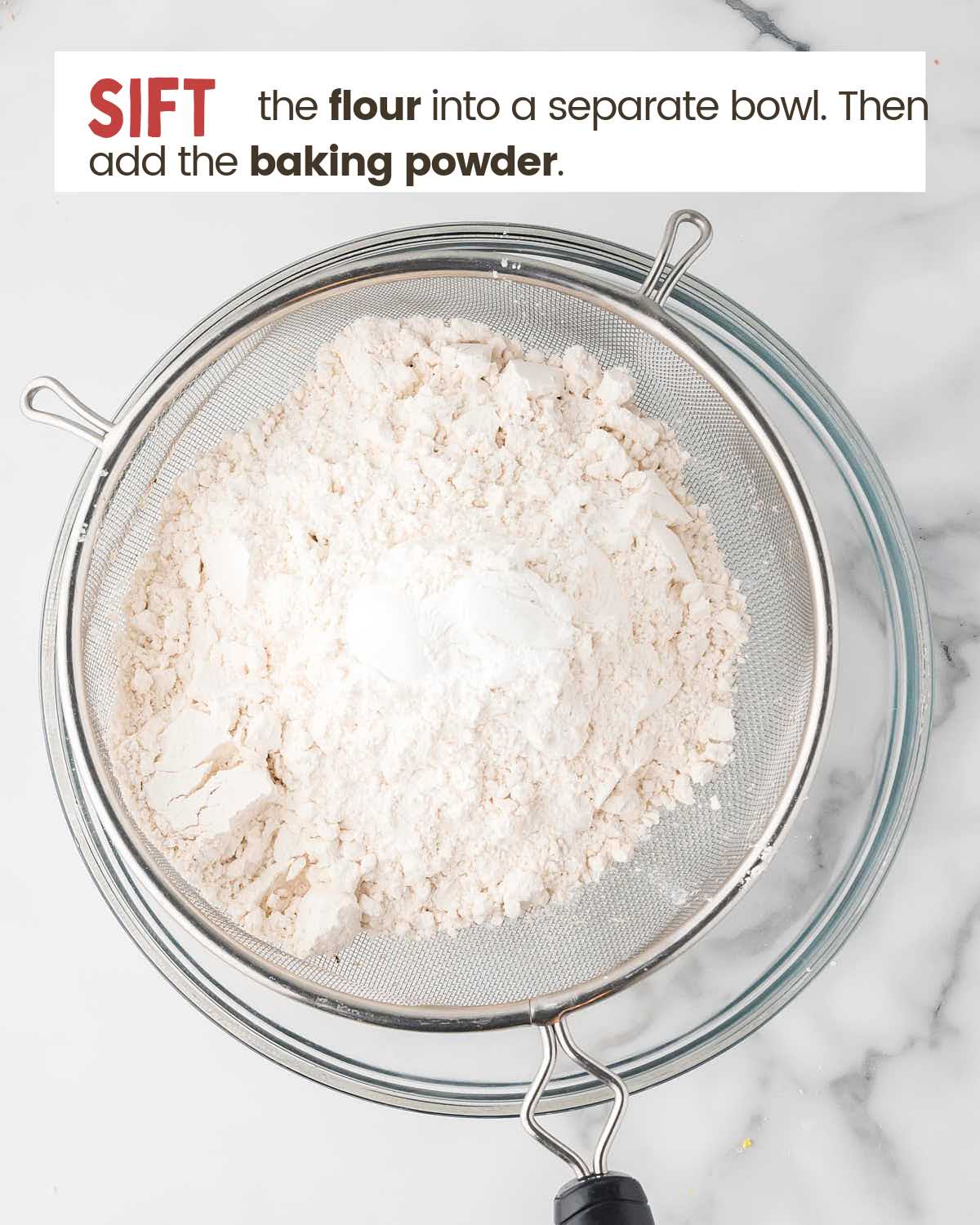 Flour in a sifter over a bowl.
