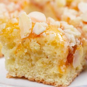 German Crumb Cake or Streuselkuchen is one of the most popular and easiest to make German baked goods. With just a handful of ingredients (and no yeast!), you can have this cake ready to serve about in 45 minutes. #cheerfulcook #Germany #baking #Streuselkuchen #crumbcake ♡ cheerfulcook.com