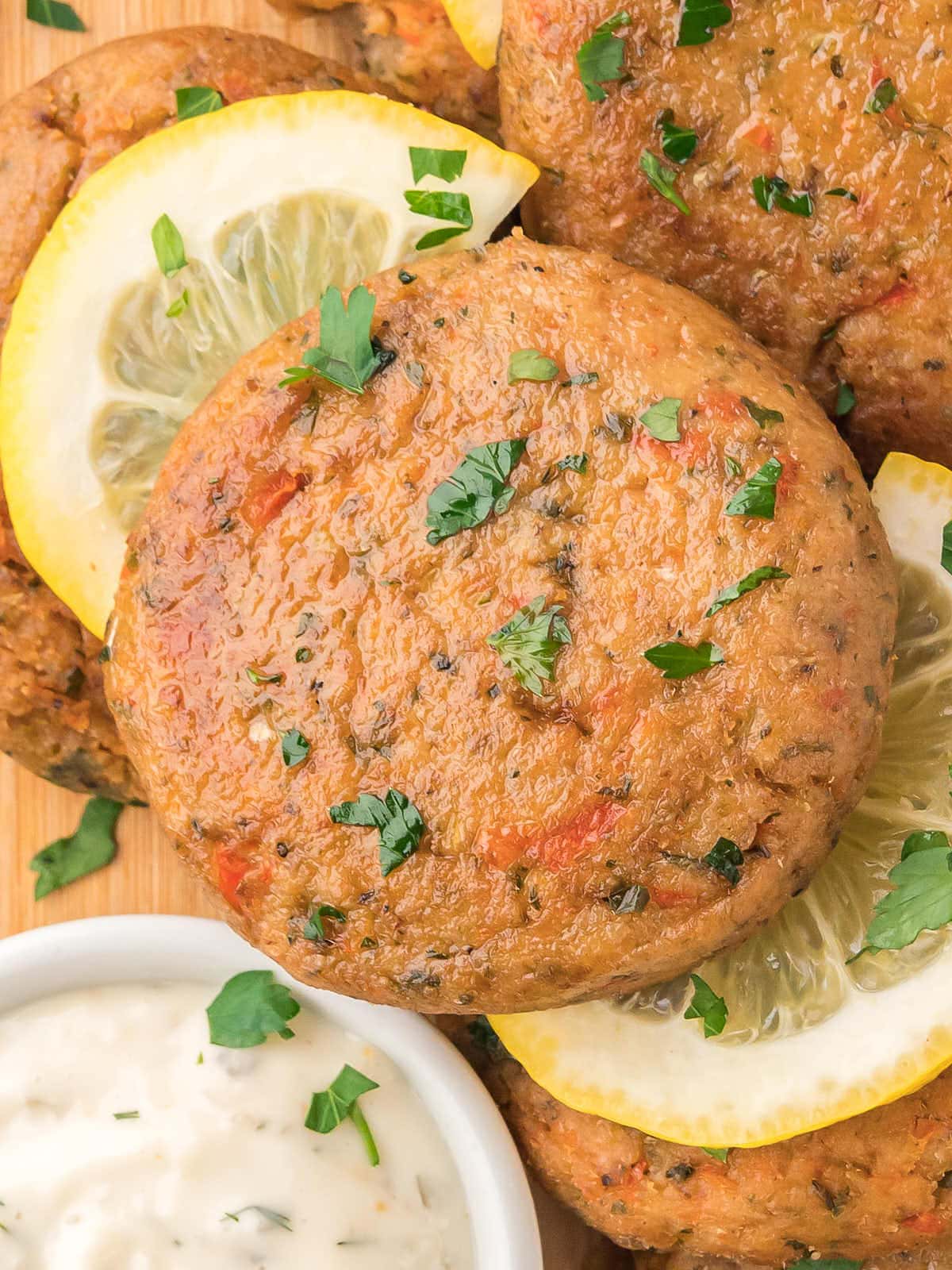 A pile o Tuna Cakes with lemon and dipping sauce.