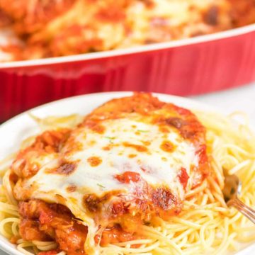 Baked cheesy Chicken Parmesan served over pasta.