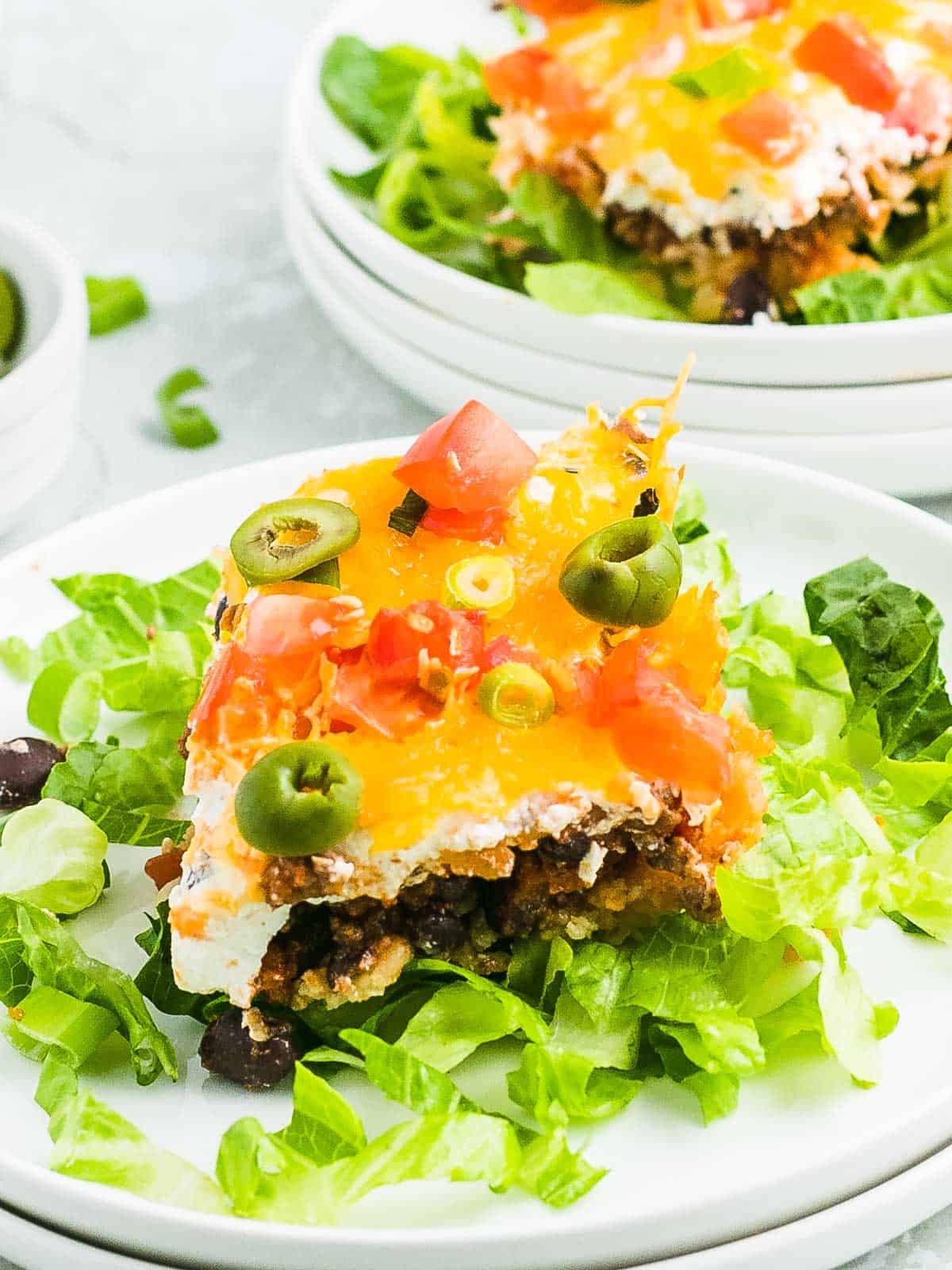 Taco Casserole served on lettuce on a white plate. 