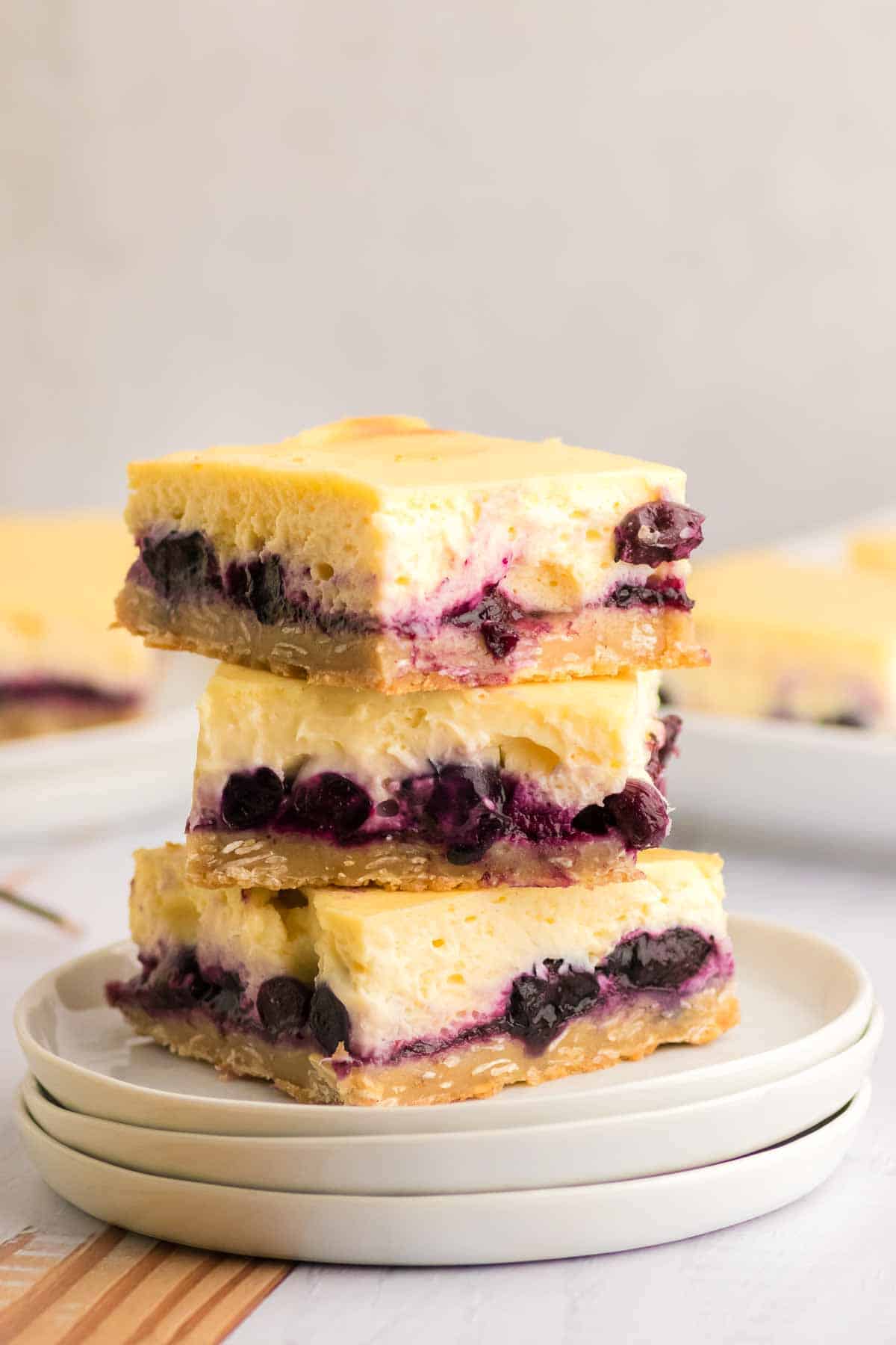 a stack of blueberry bars on white plates