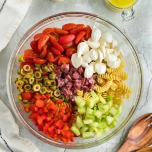 a large salad bowl filled with all the ingredients needed to make Italian Pasta Salad