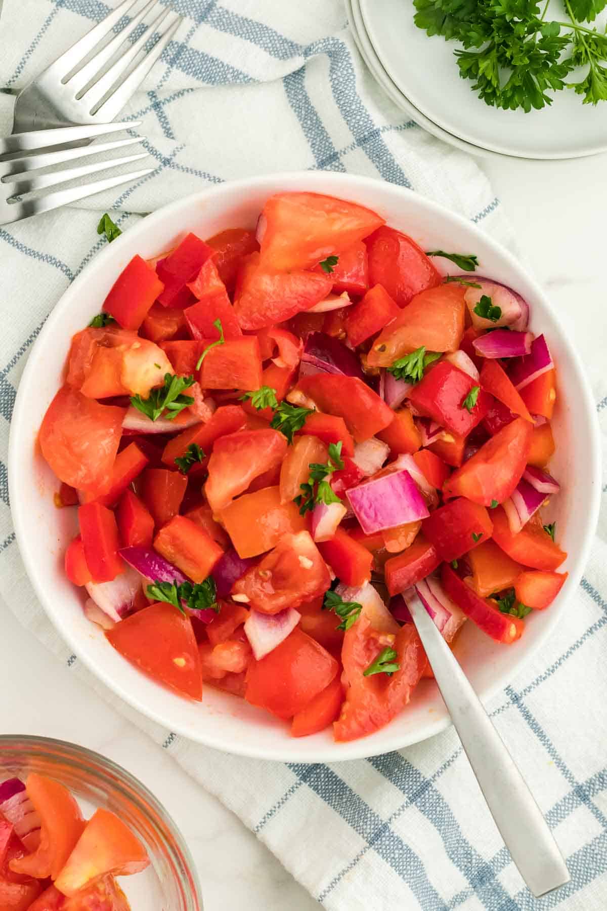 fresh tomato salad in a shallow white bowl