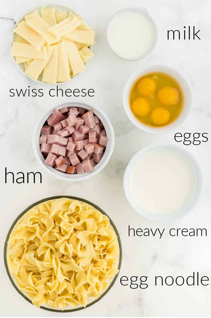 Ingredients needed to make Ham and Noodle Casserole: egg noodles, ham, heavy cream, milk, eggs, mozzarella
