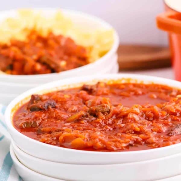 Hungarian Goulash served in white bowl over egg noodles