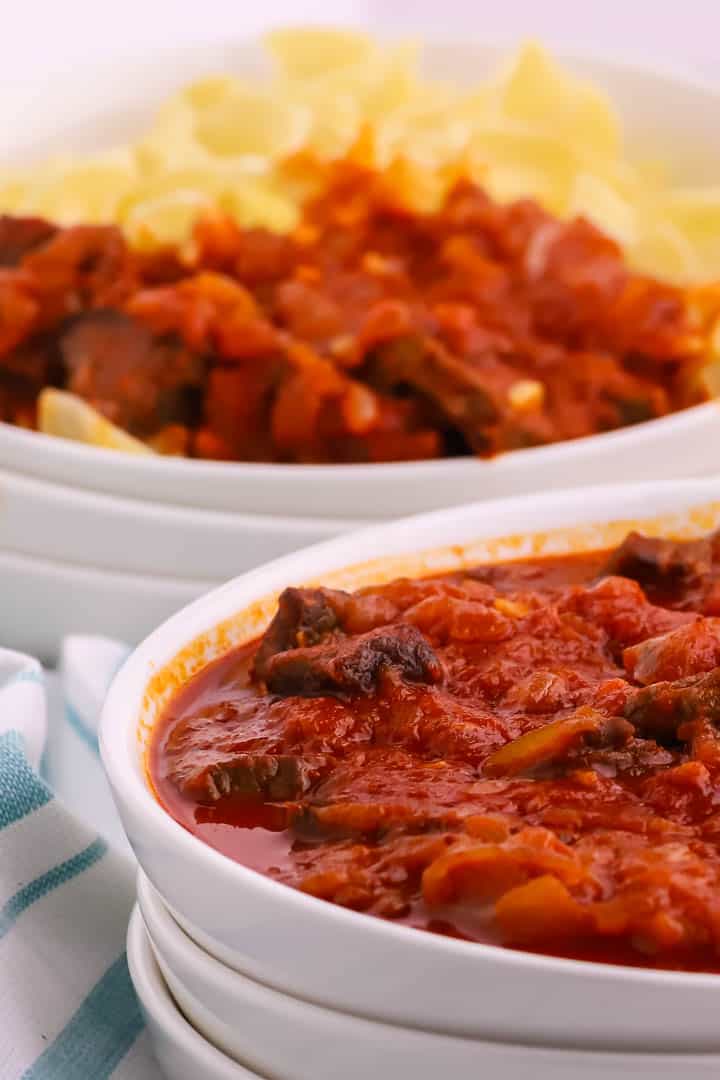 a closeup of Hungarian beef goulash in a white bowl