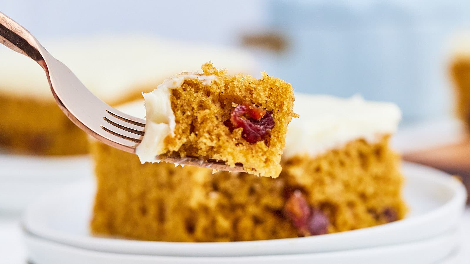 A forkful of a piece of frosted Pumpkin Bars.
