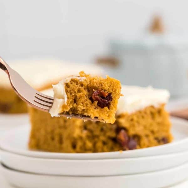 A forkful of a piece of frosted Pumpkin Bars.