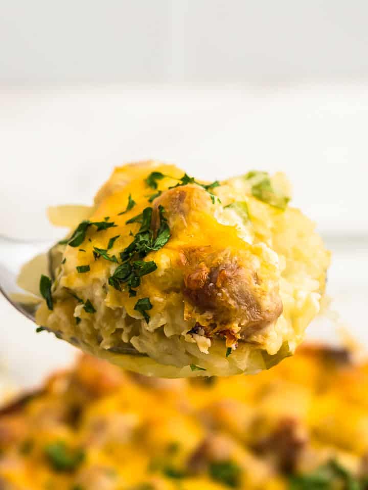 a spoonful of sausage and hashbrown casserole straight out of the casserole dish
