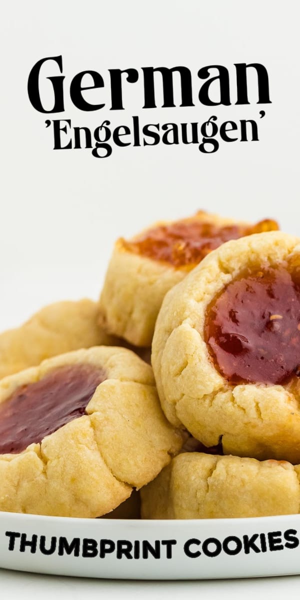 Thumbprint Cookies (German Engelsaugen) are jam-filled buttery sugar cookies. This easy cookie recipe makes a perfect little holiday treat. Easy Jam-Filled Sugar Cookies | Easy Thumbprint Cookies | Engelsaugen #cheerfulcook #jam #cookies #raspeberry #engelsaugen via @cheerfulcook