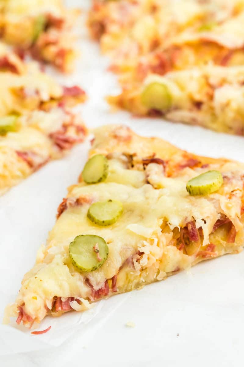 a slice of Reuben Pizza fresh from the oven