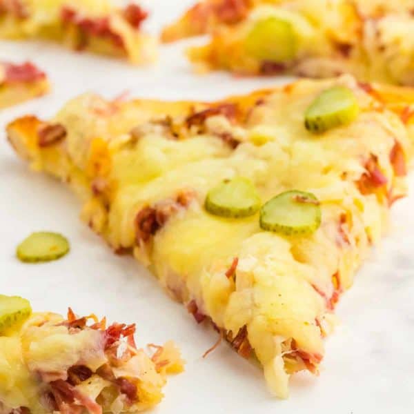 a slice of freshly baked homemade Reuben Pizza