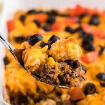 a spoonful of freshly baked taco tater tot casserole straight out of the casserole dish
