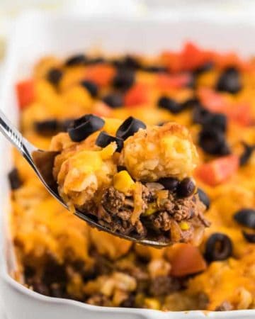 a spoonful of freshly baked taco tater tot casserole straight out of the casserole dish