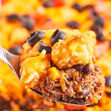 Closeup of a spoonful of freshly cooked Taco Tater Tot Casserole.