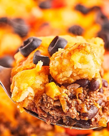Closeup of a spoonful of freshly cooked Taco Tater Tot Casserole.