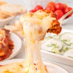 A spoonful of extra cheesy Lazy Lasagna served on a white plate.
