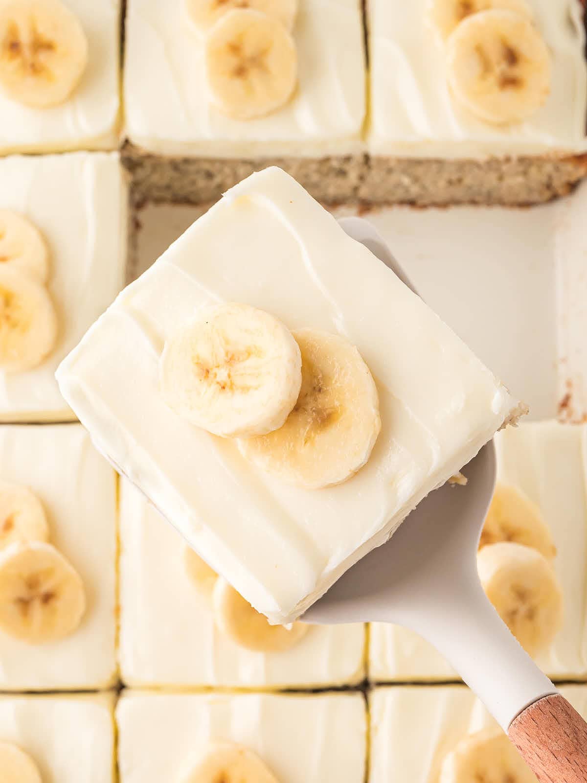Top down view of a slice of banana cake being served.