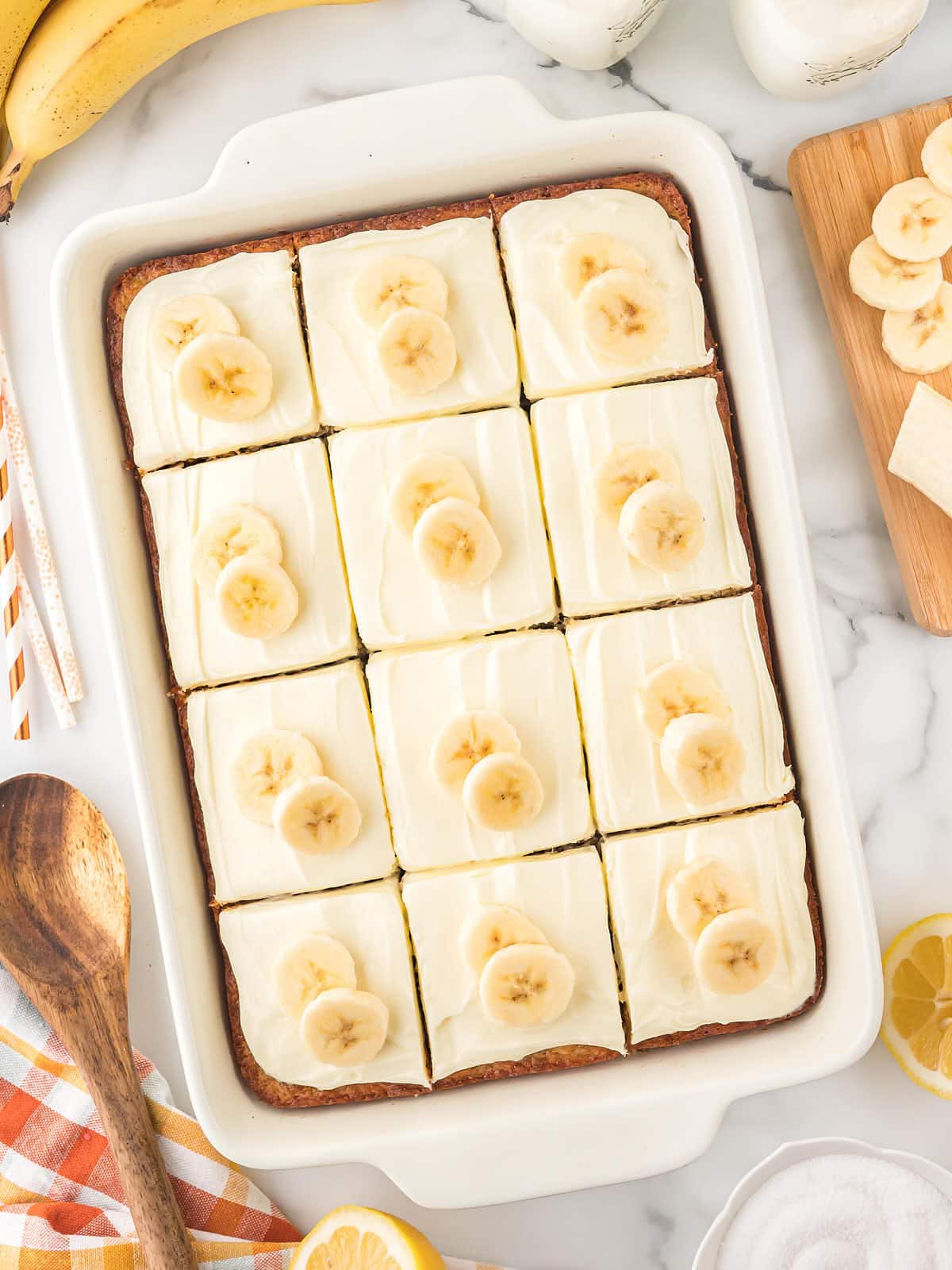 Top down-view of a Banana Cake with Cream Cheese Frosting  beautifully decorated with sliced bananas.