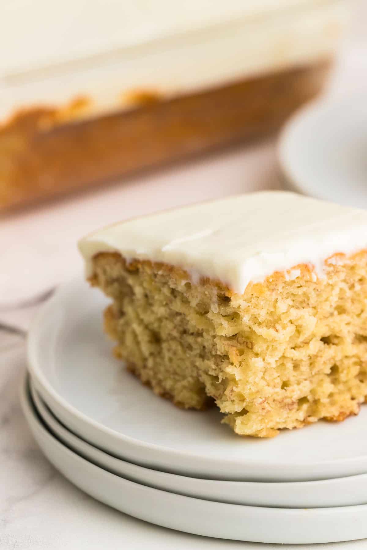 a closeup of a slice of banana cake with frosting