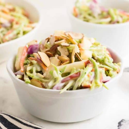 Closeup of homemade Creamy Broccoli Slaw in a white bowl.