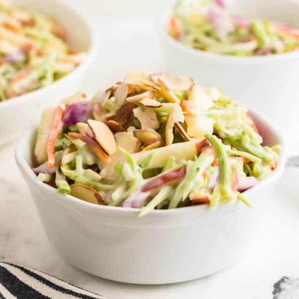 Closeup of homemade Creamy Broccoli Slaw in a white bowl.