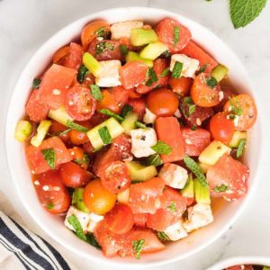 top down image of a freshly prepared watermelon salad served in a white bowl