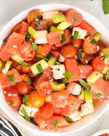 top down image of a freshly prepared watermelon salad served in a white bowl