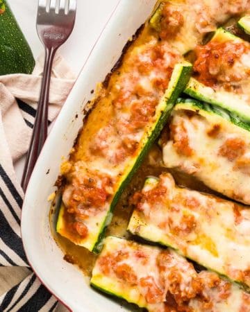 Stuffed Zucchini Boats in a casserole dish fresh from the oven.