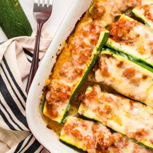 Stuffed Zucchini Boats in a casserole dish fresh from the oven.