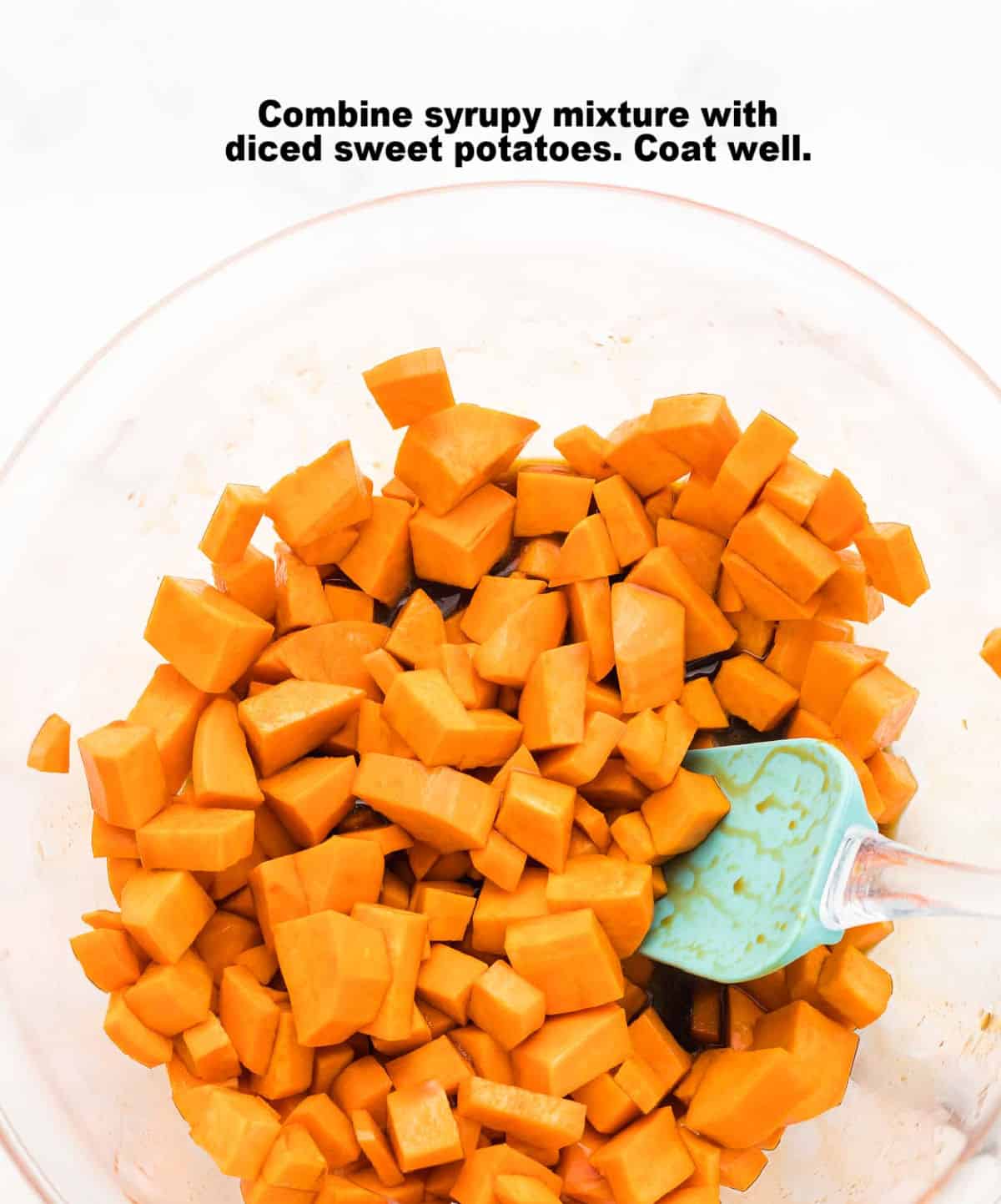 process step 2: diced sweet potatoes in a glass bowl tossed in the sugar and balsamic vinegar mixture