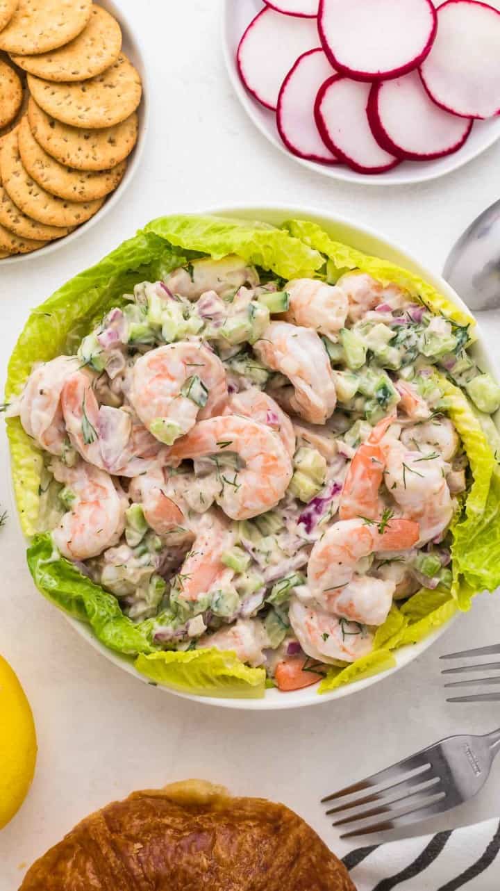 shrimp salad served as an appetizer with a side of crackers and raddishes