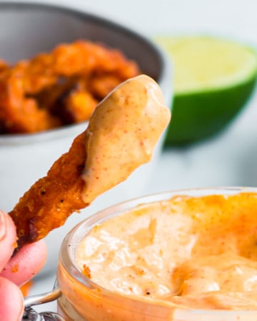 Dipping a sweet potato fries into freshly made Chipotle Mayo Dip.