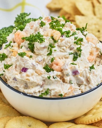 Creamy Shrimp Dip in a white bowl with crackers.