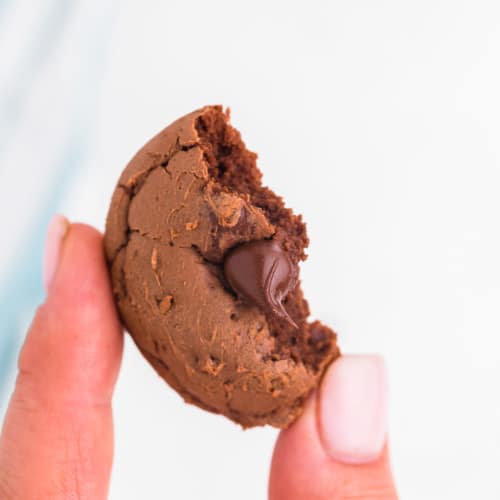 bite taken off a freshly baked double chocolate chip cookie