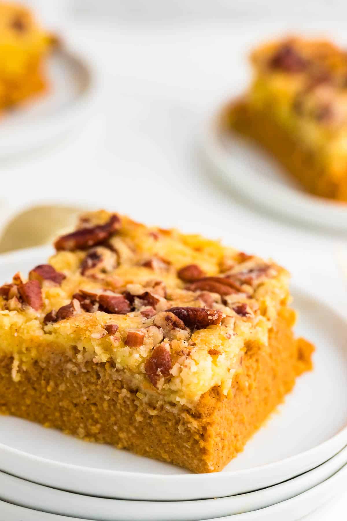 A slice of Pumpkin Dump Cake topped with pecans.