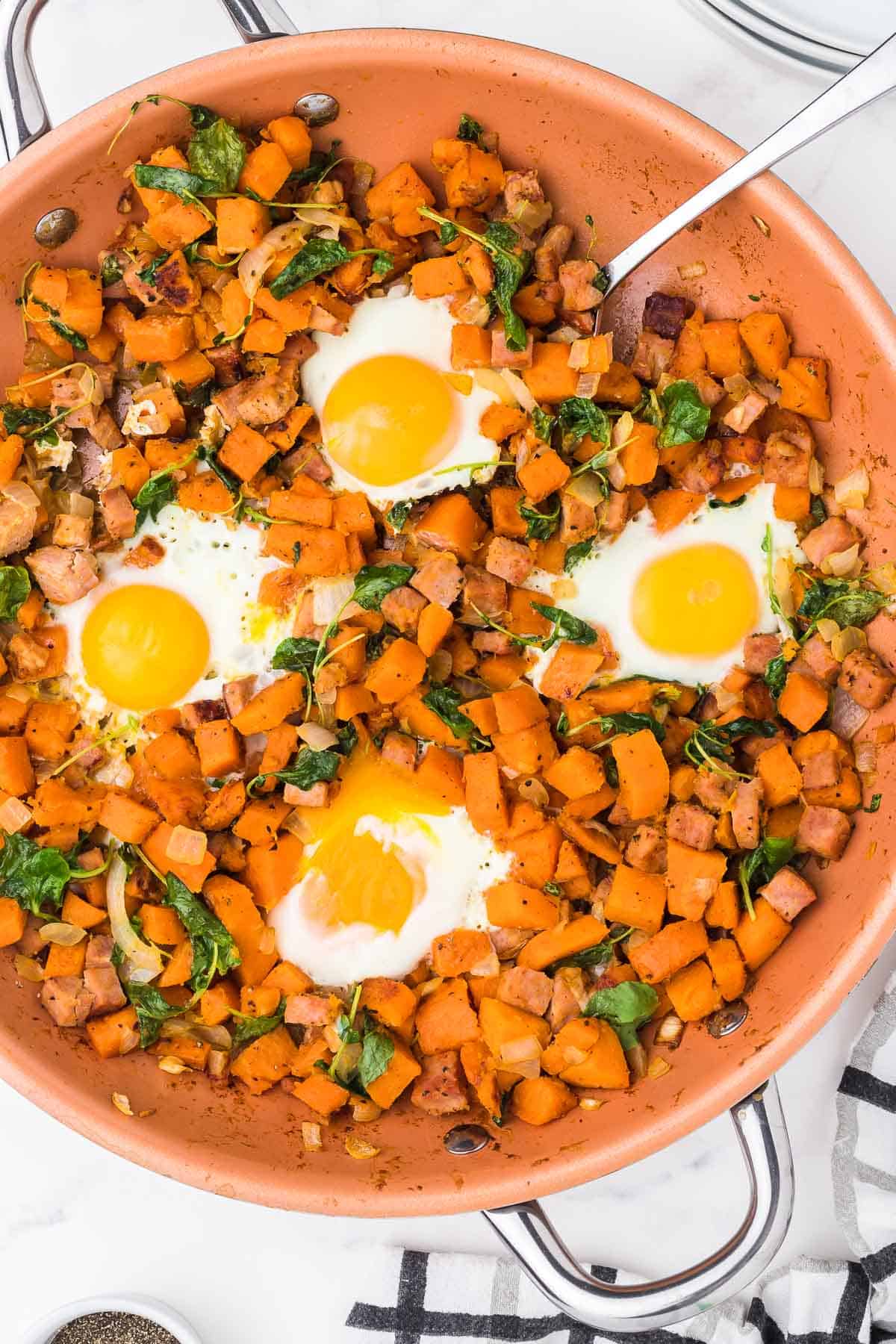 Top down view of a skillet with Sweet Potato Hash.
